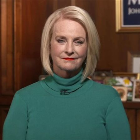 Cindy McCain poses a picture in a green top.